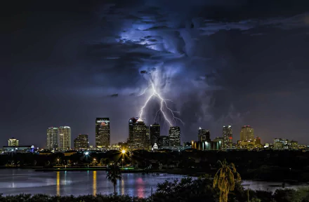 HD PC desktop wallpaper: Lightning over Tampa, Florida — dramatic storm above a man-made city skyline with reflections on water.