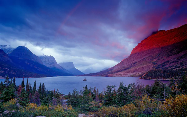 HD PC desktop wallpaper and background showing nature at Saint Mary Lake: panoramic alpine peaks, forested shoreline and calm water beneath a vivid, colorful sky.