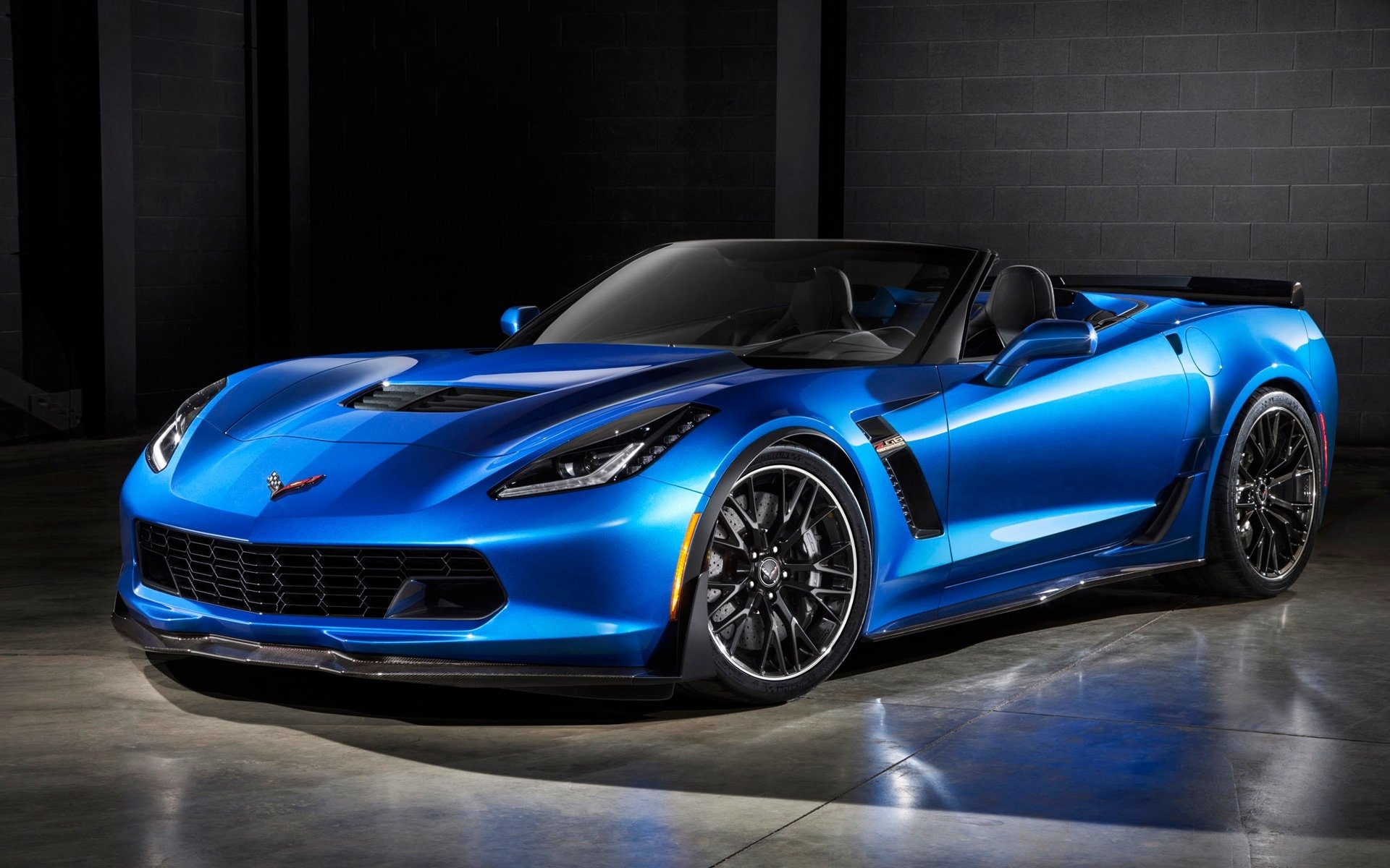 Blue Chevrolet Corvette Z06 sports car in a dark studio with glossy finish and aggressive styling — HD PC desktop wallpaper/background.
