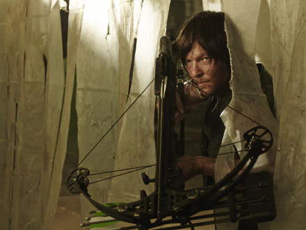 Daryl Dixon, portrayed by Norman Reedus, is captured in a tense moment aiming his crossbow in this HD wallpaper from the TV show The Walking Dead.