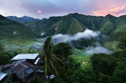 4K Ultra HD wallpaper showcasing lush tropical mountains, misty valleys, and terraced fields under a soft twilight sky.