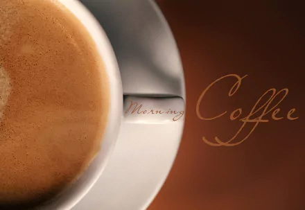 Close-up of a coffee cup with frothy coffee, featuring the words Morning Coffee in elegant script, designed as an HD PC desktop wallpaper and background.