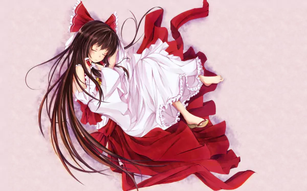 Reimu Hakurei (Touhou) anime HD PC desktop wallpaper: reclining in flowing red-and-white shrine maiden robes, long dark hair fanned out on a soft pale background.