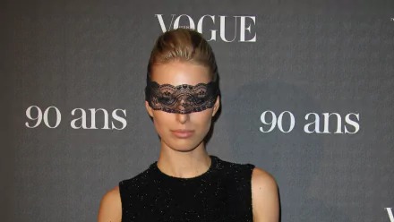 HD desktop wallpaper featuring Czech model and celebrity Karolína Kurková wearing a black lace eye mask at a Vogue event celebrating 90 years.