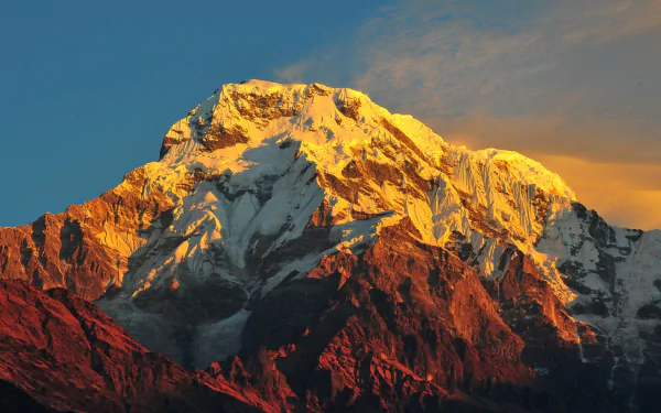 HD desktop wallpaper featuring a stunning view of nature with Mount Everest bathed in golden sunlight against a clear sky.