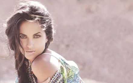 A striking HD desktop wallpaper featuring Mexican actress Barbara Mori, showcasing her captivating gaze and stylish outfit against a soft, blurred background.