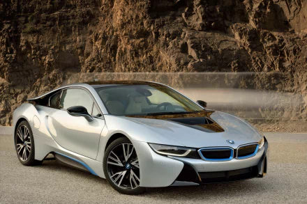 HD wallpaper featuring a BMW i8 against a rocky landscape, highlighting the sleek design and modern aesthetics of the vehicle.