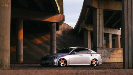 4K Ultra HD PC desktop wallpaper background: silver Lexus IS 250 (Lexus IS) vehicle parked under a concrete overpass with custom bronze wheels.