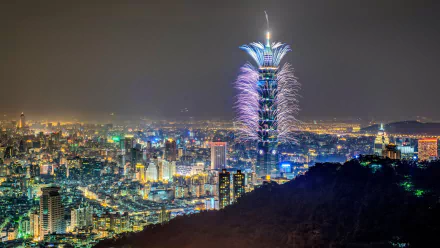 Night view of Taipei cityscape featuring Taipei 101 illuminated with fireworks, captured in stunning 4K Ultra HD detail as a man-made urban landscape.