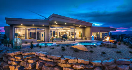 Luxury modern house in Utah with a landscaped garden and illuminated pool under a vibrant evening sky, captured in HD for a desktop wallpaper background.