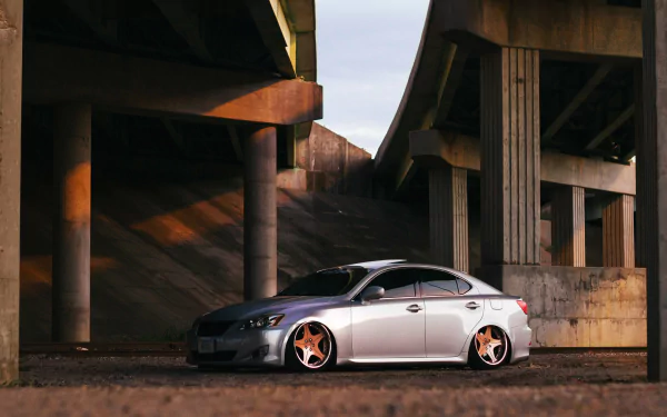 4K Ultra HD PC desktop wallpaper background: silver Lexus IS 250 (Lexus IS) vehicle parked under a concrete overpass with custom bronze wheels.