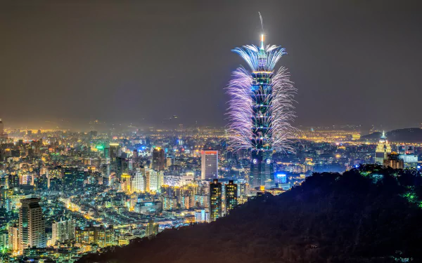 Night view of Taipei cityscape featuring Taipei 101 illuminated with fireworks, captured in stunning 4K Ultra HD detail as a man-made urban landscape.