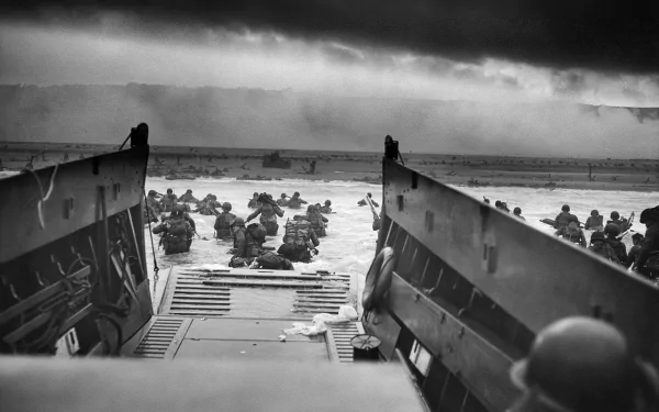 Black and white HD desktop wallpaper depicting soldiers landing on a beach during D-Day, capturing a historic military moment.