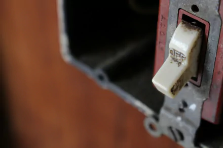 HD desktop wallpaper featuring a close-up of an old, worn light switch in its mounting box with a blurred background.