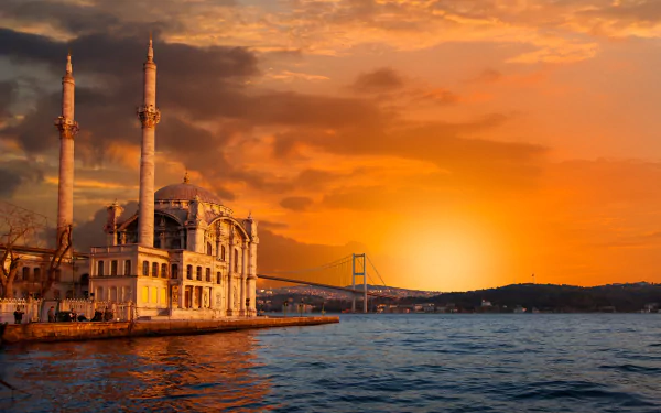 A stunning HD wallpaper featuring a silhouette of a mosque and the Bosphorus Bridge at sunset, highlighting the man-made beauty of Istanbul against a vibrant sky.
