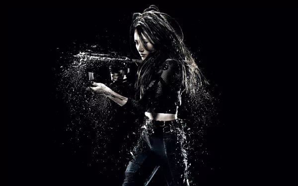 HD PC desktop wallpaper featuring Maggie Q as her character in the movie Insurgent, holding a gun against a dark, water-splashed background.