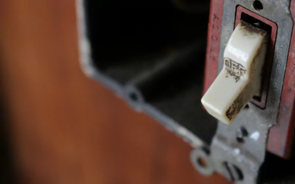 HD desktop wallpaper featuring a close-up of an old, worn light switch in its mounting box with a blurred background.