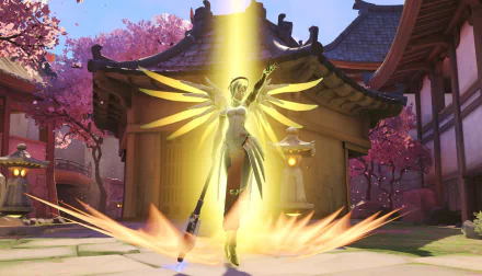 HD PC desktop wallpaper featuring Mercy from Overwatch, glowing warmly with golden wings in front of a traditional Japanese-style building surrounded by cherry blossoms.