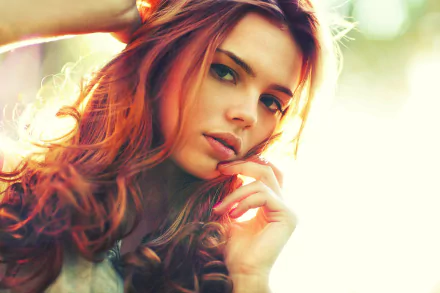 HD desktop wallpaper featuring a redhead model, showcasing her flowing hair and striking face for a vibrant background.
