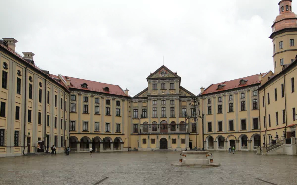 Man-made Nesvizh Castle courtyard under an overcast sky with symmetrical baroque facades — HD PC desktop wallpaper and background.