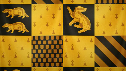 A vibrant Hufflepuff-themed wallpaper featuring badgers and yellow patterns, inspired by the Harry Potter fantasy universe, adds a touch of magic to your desktop.