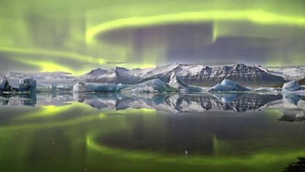 A stunning view of the aurora borealis dancing over icy landscapes, reflected in tranquil waters, creating a captivating nature scene in high-definition.