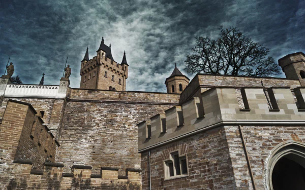 HD desktop wallpaper showcasing the man-made Hohenzollern Castle under a dramatic cloudy sky.