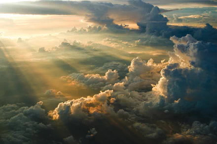 HD desktop wallpaper featuring a breathtaking view of sunbeams piercing through majestic clouds, creating a luminous and dynamic backdrop.