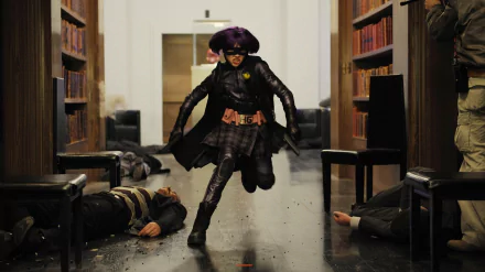 HD PC desktop wallpaper featuring Hit-Girl, played by Chloë Grace Moretz, in action from the movie Kick-Ass, running through a hallway with fallen foes around her.