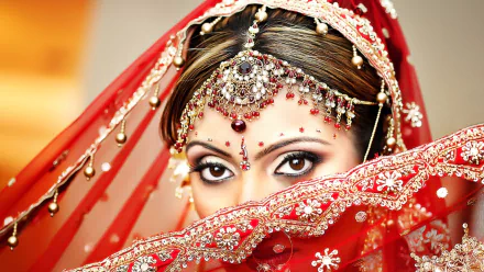 HD desktop wallpaper featuring a close-up portrait of an Indian woman in traditional bridal attire with intricate jewelry and a red veil.
