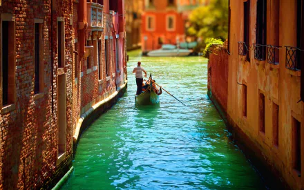 A serene scene in Venice, featuring a gondola gliding through a peaceful canal, surrounded by charming man-made buildings and vibrant reflections in the water.