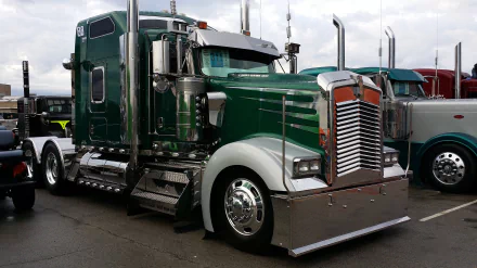 A green Kenworth truck parked with chrome details, captured in 4K Ultra HD as a PC desktop wallpaper background.