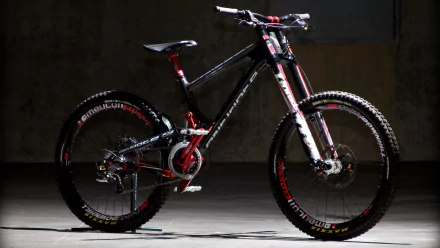 HD wallpaper featuring a sleek black and red mountain bike with high-performance components, showcased against a dark, minimalist background.