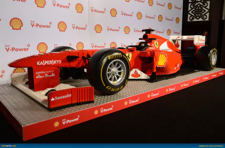 HD desktop wallpaper of a man-made LEGO replica of the Ferrari F150 Italia F1 racing car, showcasing detailed construction and vibrant Ferrari branding.