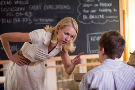 HD PC desktop wallpaper from the movie Movie 43 featuring a blonde woman leaning forward and pointing her finger at a seated young man in a classroom setting.