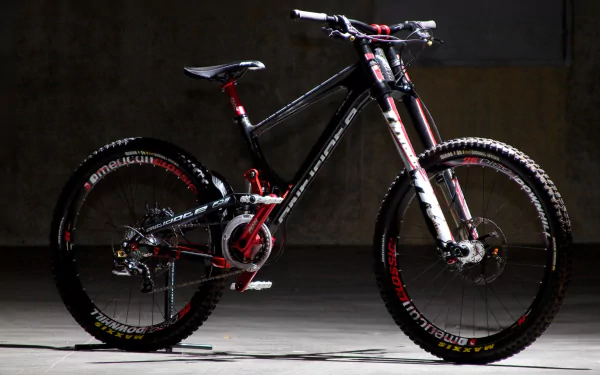 HD wallpaper featuring a sleek black and red mountain bike with high-performance components, showcased against a dark, minimalist background.