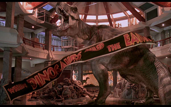 HD desktop wallpaper from Jurassic Park featuring a T-Rex in the visitor center causing destruction.