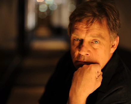 HD desktop wallpaper featuring a contemplative Mark Hamill with a blurred background.