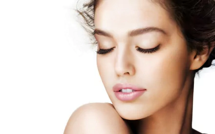 Close-up HD portrait of celebrity Emily Didonato with eyes closed, showcasing smooth skin and natural makeup, designed as a PC desktop wallpaper and background.