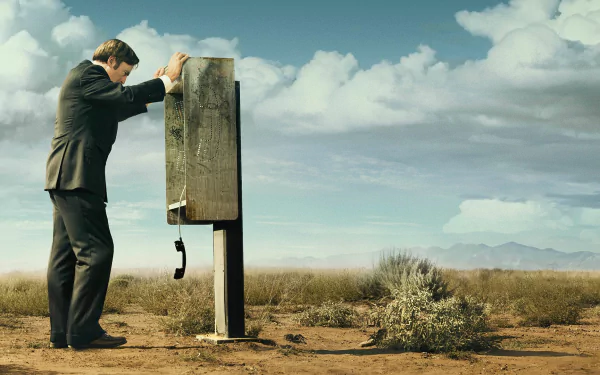 HD wallpaper featuring Bob Odenkirk as Jimmy McGill from Better Call Saul, leaning on a payphone in the desert.