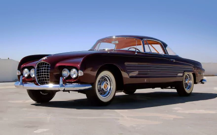 HD desktop wallpaper featuring a 1953 Ghia Cadillac, showcasing its sleek vintage design against a clear blue sky.