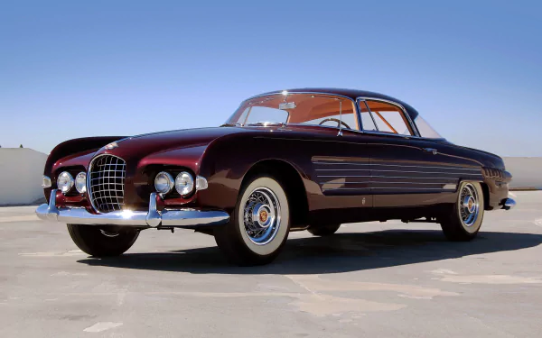 HD desktop wallpaper featuring a 1953 Ghia Cadillac, showcasing its sleek vintage design against a clear blue sky.
