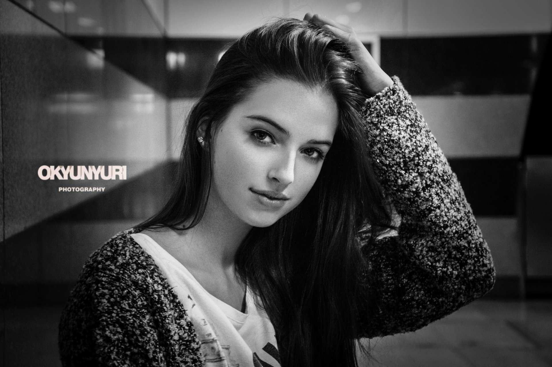 Black and white vintage-style HD desktop wallpaper featuring a smiling woman with long hair, captured in a monochrome close-up portrait.