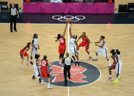 A dynamic basketball scene captures the jump ball between teams at the Olympics, showcasing the intensity of the game. This 4K Ultra HD image serves as a vivid desktop wallpaper.