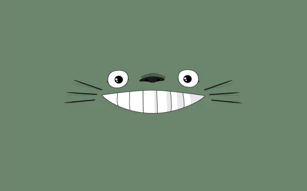 A whimsical HD desktop wallpaper featuring Totoro, the iconic character from My Neighbor Totoro, showcasing his playful smile against a simple green background.