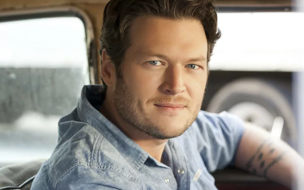 Blake Shelton, a prominent country music artist, is pictured sitting in a car, offering a captivating backdrop for an HD desktop wallpaper celebrating his musical career.