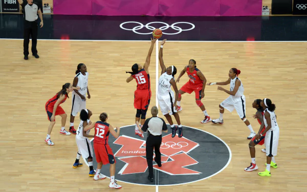 A dynamic basketball scene captures the jump ball between teams at the Olympics, showcasing the intensity of the game. This 4K Ultra HD image serves as a vivid desktop wallpaper.