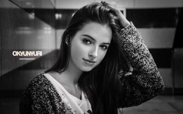 Black and white vintage-style HD desktop wallpaper featuring a smiling woman with long hair, captured in a monochrome close-up portrait.