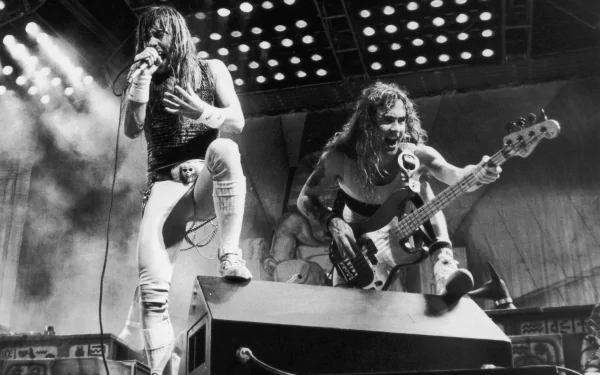 Black and white 4K Ultra HD desktop wallpaper featuring Iron Maiden's dynamic live performance with the lead singer and bassist on stage.