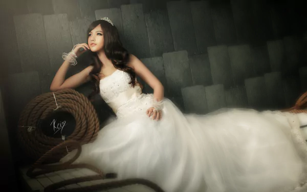 A stunning Vietnamese bride models an elegant wedding dress in this HD desktop wallpaper, showcasing graceful beauty and intricate gown details.